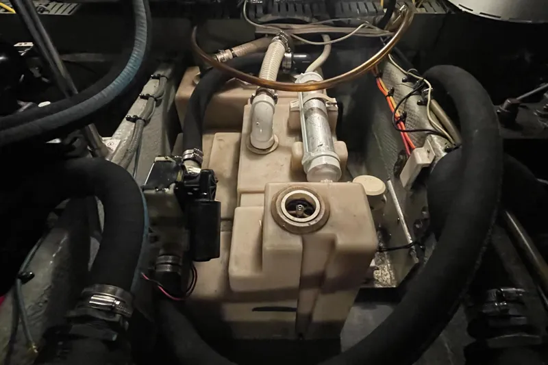 Mary Jean Too Yacht Photos Pics Engine compartment of a 2003 Mainship 430 Trawler, featuring hoses and components.