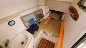  Yacht Photos Pics 2013 Grady-White Freedom 307 cabin interior with seating, sink, and fishing gear.