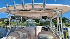  Yacht Photos Pics 2013 Grady-White Freedom 307 boat interior with seating and rod holders, docked by waterfront homes.