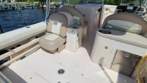  Yacht Photos Pics 2013 Grady-White Freedom 307 boat interior with seating and storage, docked by the water.