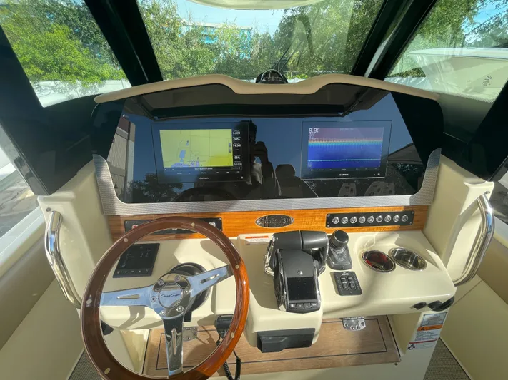  Yacht Photos Pics 2022 Chris-Craft Catalina 30 helm with modern navigation displays and wooden steering wheel.