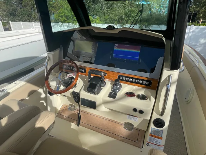  Yacht Photos Pics 2022 Chris-Craft Catalina 30 helm with modern controls and navigation screens.