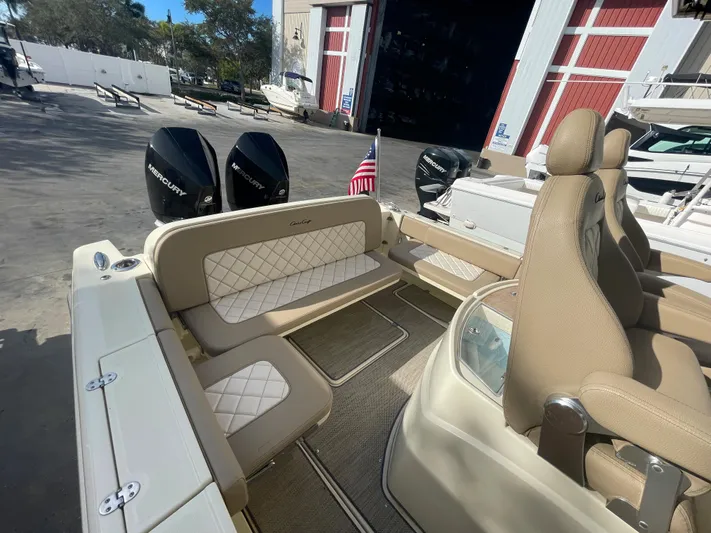  Yacht Photos Pics 2022 Chris-Craft Catalina 30 boat interior with beige seating and dual Mercury engines.