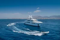Luxurious R.B Dereli 2004 yacht cruising in clear blue waters with scenic mountain backdrop.