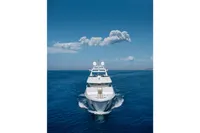 Luxury yacht cruising on open sea under clear blue sky, R.B Dereli 2004 model.