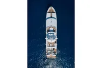 Aerial view of 2004 R.B Dereli yacht cruising on deep blue ocean waters.