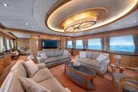 Luxurious yacht interior with elegant sofas, large windows, and modern lighting, R.B Dereli 2004 model.