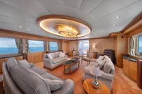Luxurious yacht interior with elegant seating, large windows, and modern lighting, R.B Dereli 2004 model.