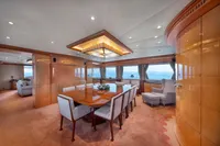 Luxurious yacht interior with elegant dining area, panoramic windows, and plush seating, R.B Dereli 2004 model.