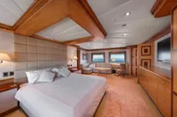 Luxurious yacht bedroom with elegant wood paneling, large bed, and ocean view windows, R.B Dereli 2004.