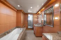 Luxurious yacht bathroom with wood paneling, granite countertops, and elegant lighting, R.B Dereli 2004 model.
