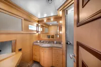 Luxurious yacht bathroom with wooden cabinetry, granite countertop, and modern lighting, R.B Dereli 2004 model.