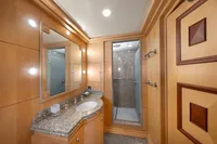 Luxurious yacht bathroom with granite countertop, wooden cabinetry, and modern shower, R.B Dereli 2004 model.