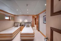 Luxurious yacht cabin with twin beds, modern lighting, and elegant wood accents, R.B Dereli 2004 model.