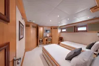 Luxurious yacht cabin interior with twin beds, wooden decor, and ensuite bathroom, R.B Dereli 2004 model.