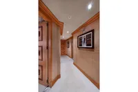 Luxurious yacht interior hallway with artwork, wooden accents, and soft lighting, R.B Dereli 2004 model.