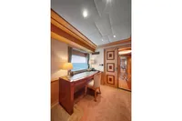 Luxurious yacht interior with desk, chair, and ocean view window, R.B Dereli 2004 model.