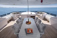 Luxurious yacht deck with dining table, fruit platter, and sea view, R.B Dereli 2004 model.