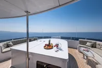 Luxurious yacht deck with fruit platter and wine, R.B Dereli 2004 model, ocean view.