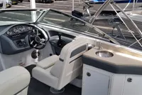 2016 Cobalt 24 boat interior with steering wheel, seating, and sink.