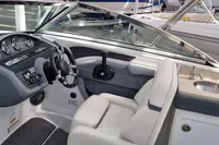 2016 Cobalt 24 boat interior with steering wheel, gauges, and sink.