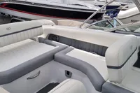 2016 Cobalt 24 boat interior with white and gray seating, docked among other boats.