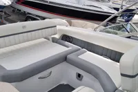 2016 Cobalt 24 boat interior with white and gray seating, docked among other boats.