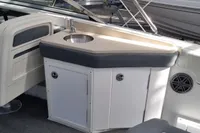 2016 Cobalt 24 boat interior with sink and seating area.
