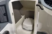 Interior of 2016 Cobalt 24 boat featuring a compact marine toilet.