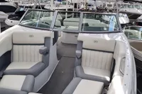 2016 Cobalt 24 boat interior with white and gray seating, docked among other boats.