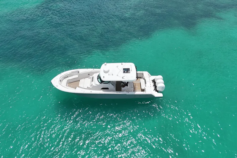  Yacht Photos Pics 2022 Bertram 39 CC boat on clear turquoise water, aerial view.