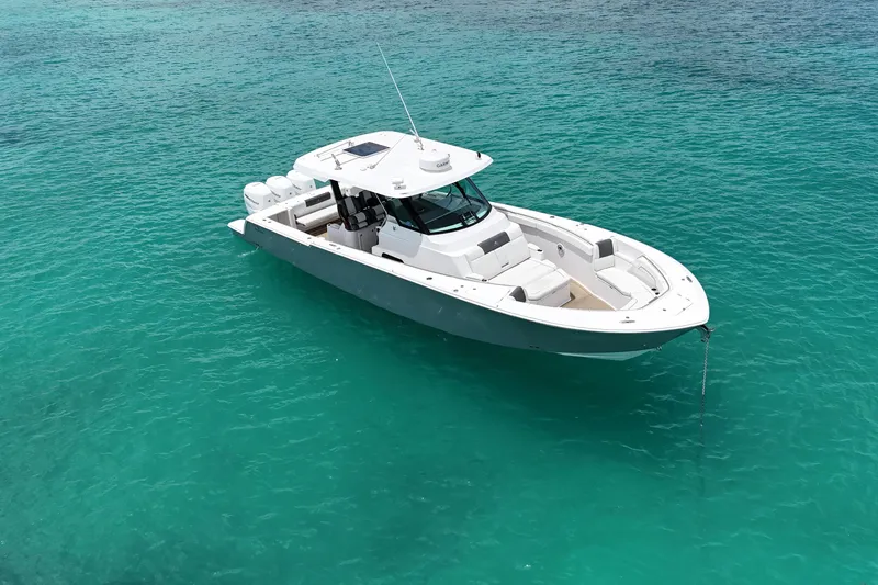  Yacht Photos Pics 2022 Bertram 39 CC boat on clear turquoise water, aerial view.