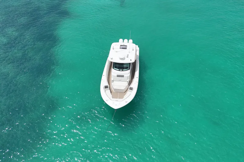  Yacht Photos Pics Aerial view of 2022 Bertram 39 CC boat on turquoise water.