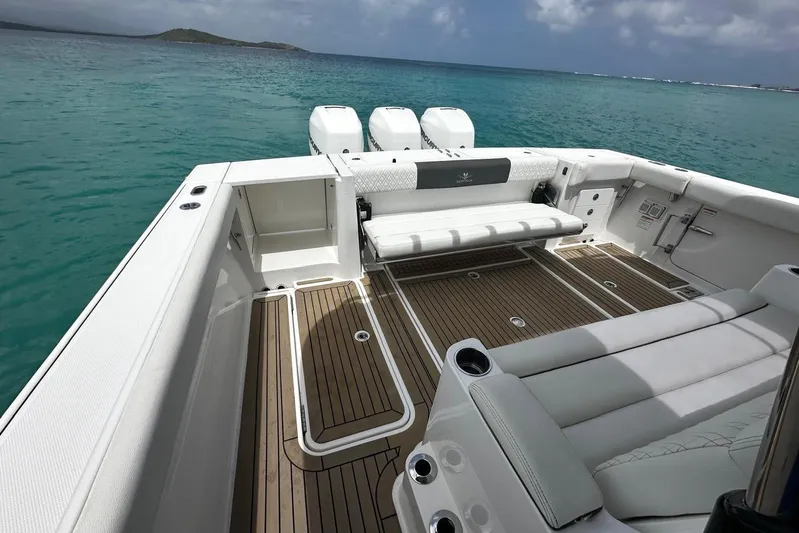  Yacht Photos Pics 2022 Bertram 39 CC boat deck with seating, overlooking turquoise ocean waters.