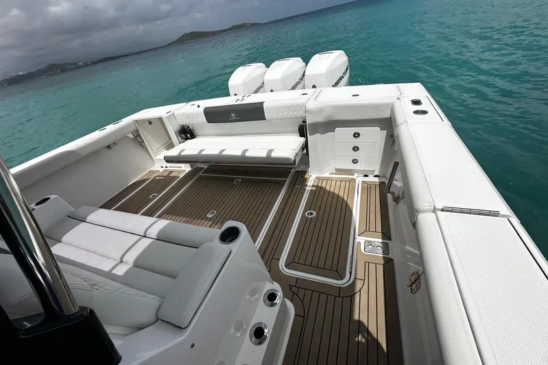  Yacht Photos Pics 2022 Bertram 39 CC boat interior with sleek seating and triple outboard engines.