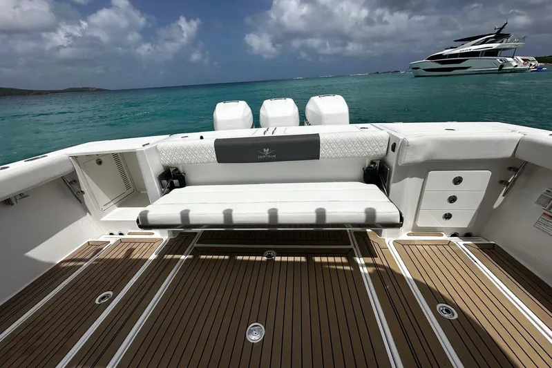  Yacht Photos Pics 2022 Bertram 39 CC boat deck with seating, ocean view, and luxury yacht in background.