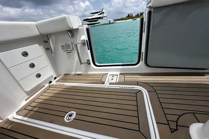  Yacht Photos Pics 2022 Bertram 39 CC boat interior with teak flooring, open door, and ocean view.