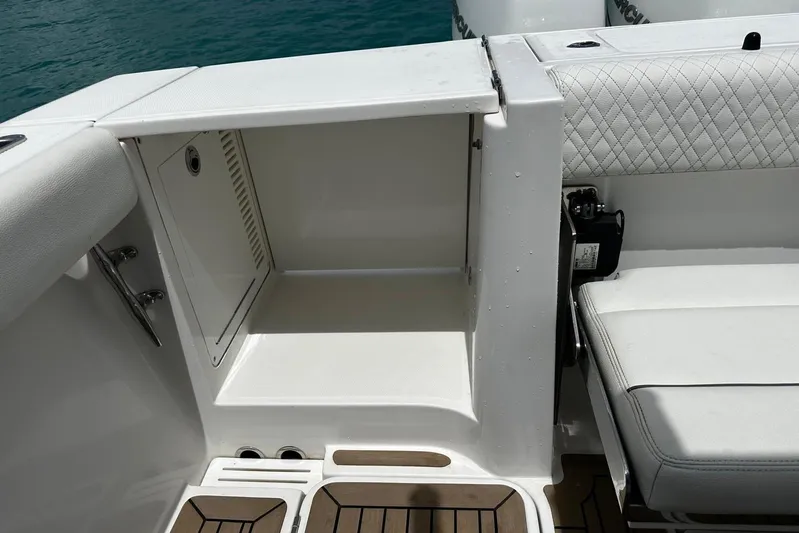  Yacht Photos Pics 2022 Bertram 39 CC boat interior with open storage compartment and cushioned seating.