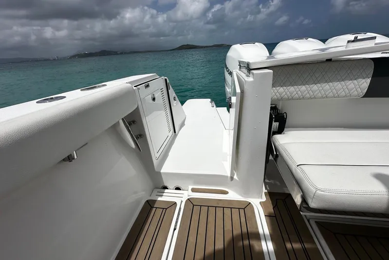  Yacht Photos Pics 2022 Bertram 39 CC boat interior with seating, ocean view, and cloudy sky.