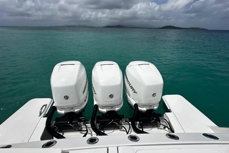  Yacht Photos Pics 2022 Bertram 39 CC boat with triple Mercury outboard engines on open water.