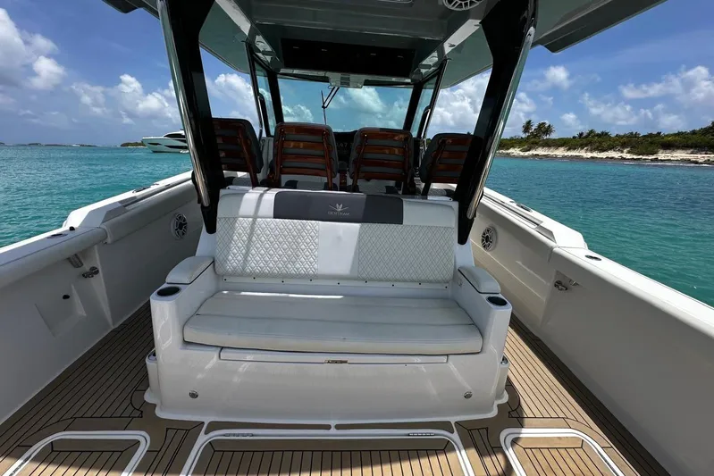  Yacht Photos Pics 2022 Bertram 39 CC boat interior with seating, on clear blue water.