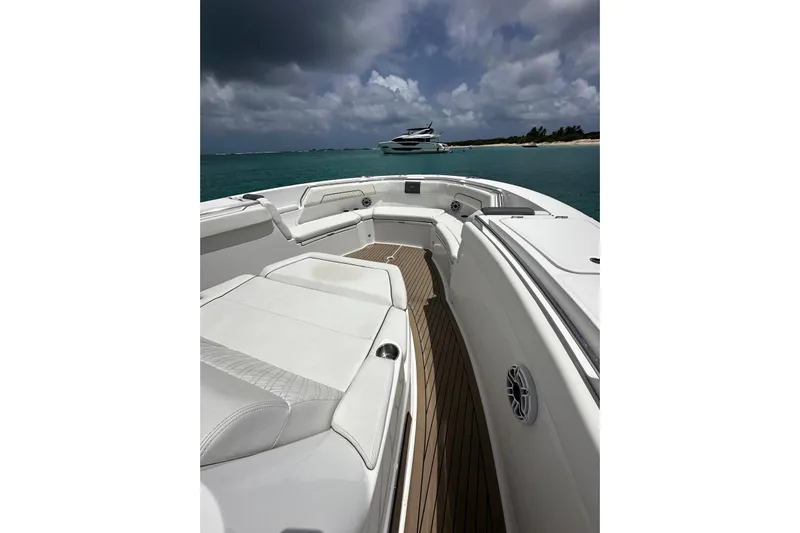  Yacht Photos Pics 2022 Bertram 39 CC boat interior with white seating, ocean view, and cloudy sky.
