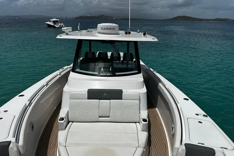  Yacht Photos Pics 2022 Bertram 39 CC boat on clear turquoise water, featuring Garmin equipment.