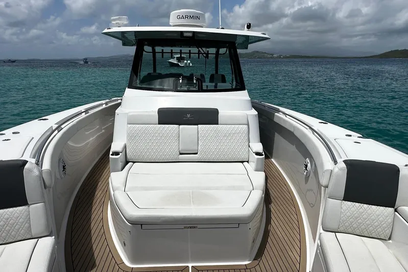  Yacht Photos Pics 2022 Bertram 39 CC boat with luxurious seating on calm ocean waters.