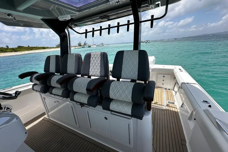  Yacht Photos Pics 2022 Bertram 39 CC boat interior with luxurious seating, overlooking turquoise waters.