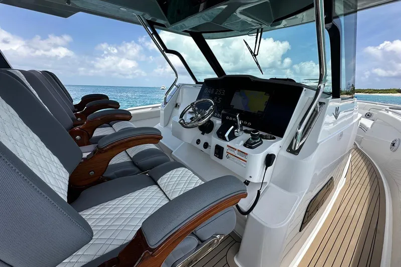  Yacht Photos Pics 2022 Bertram 39 CC boat cockpit with modern controls and luxurious seating.