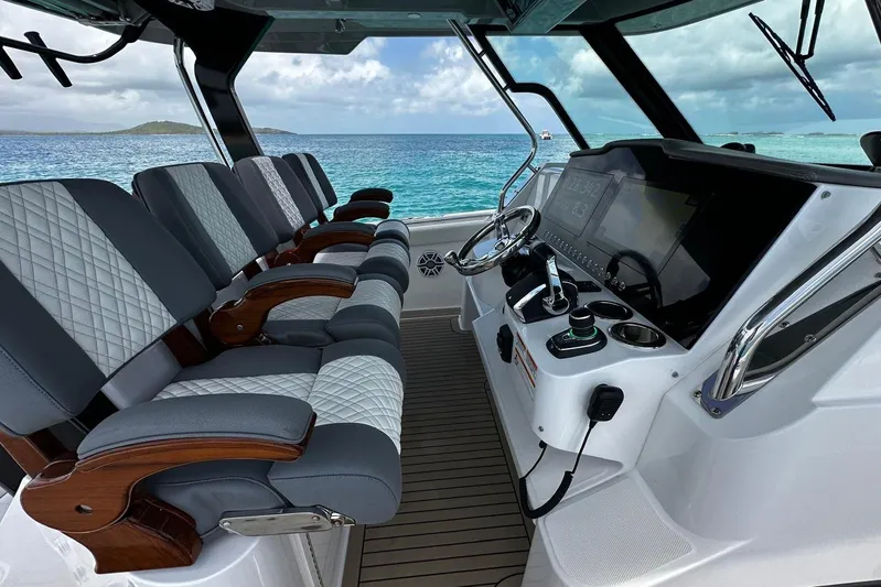  Yacht Photos Pics 2022 Bertram 39 CC boat interior with luxury seating and modern helm controls.