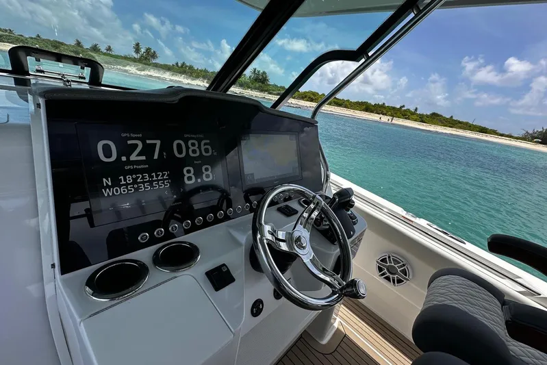  Yacht Photos Pics 2022 Bertram 39 CC helm with GPS display, steering wheel, and ocean view.
