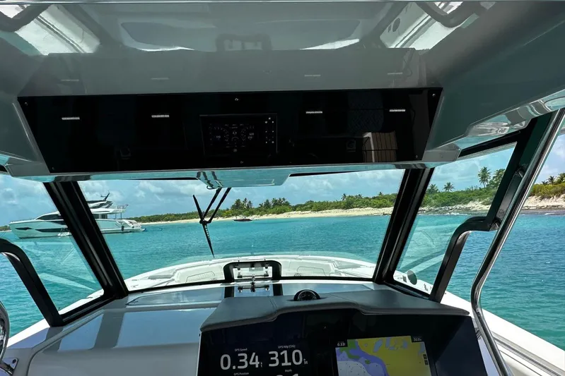  Yacht Photos Pics 2022 Bertram 39 CC boat interior with ocean view and navigation display.