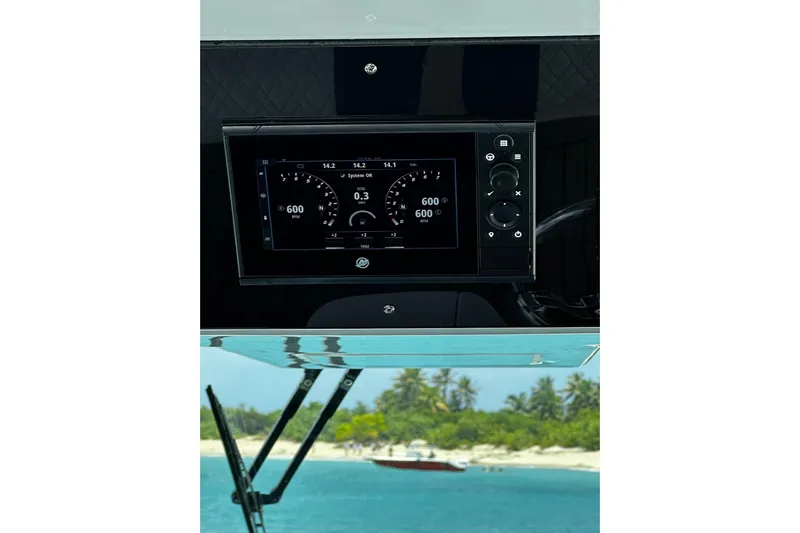  Yacht Photos Pics Dashboard of 2022 Bertram 39 CC boat with digital display, tropical beach view.